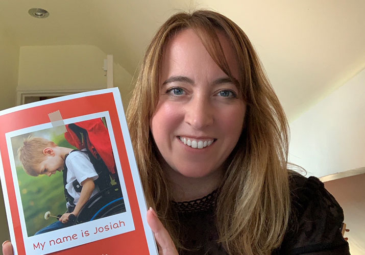 Lindsay Tomlinson holding a copy of the 'My Name Is Josiah' book
